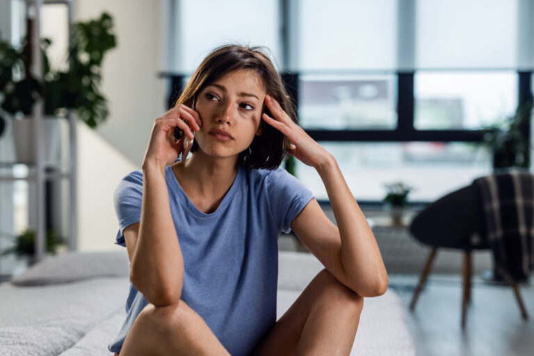woman sitting on floor of living room dealing with what might potentially be insanity in las vegas