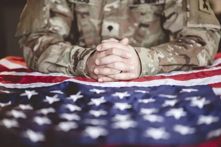 Veteran hands on flag