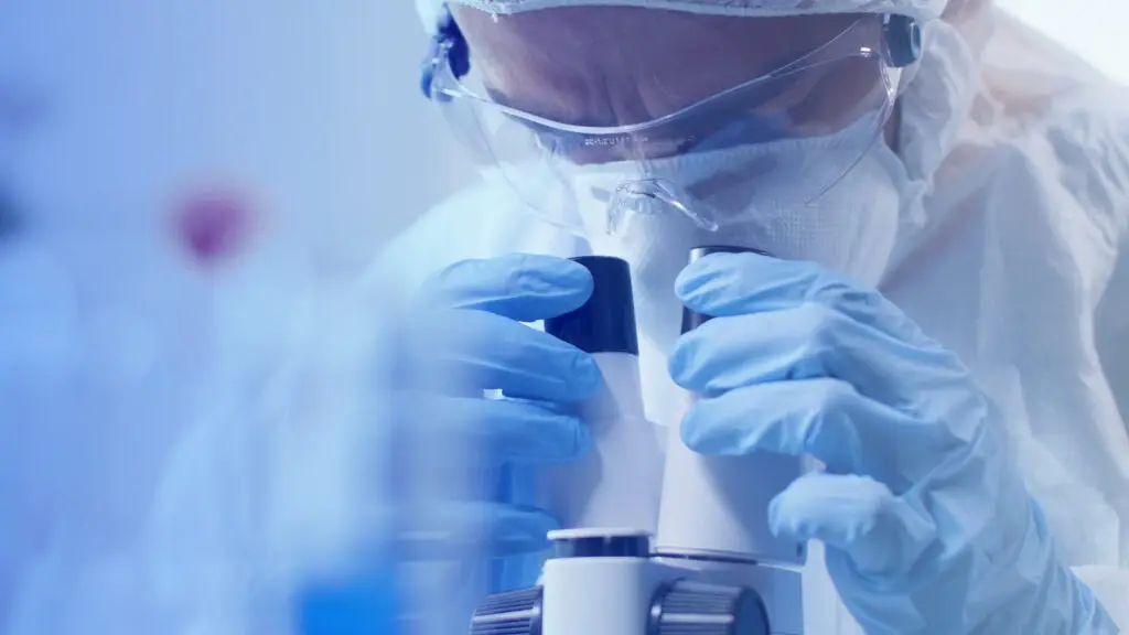 Doctor looking through a microscope