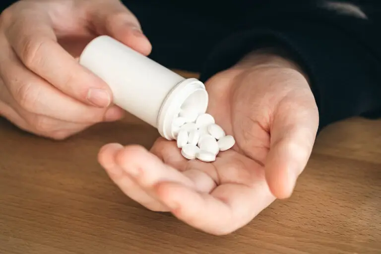 Man pouring pills into his hand