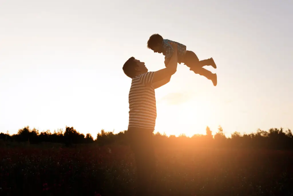 Happy father holding child in the air in Henderson NV after psychiatric services at MindWell