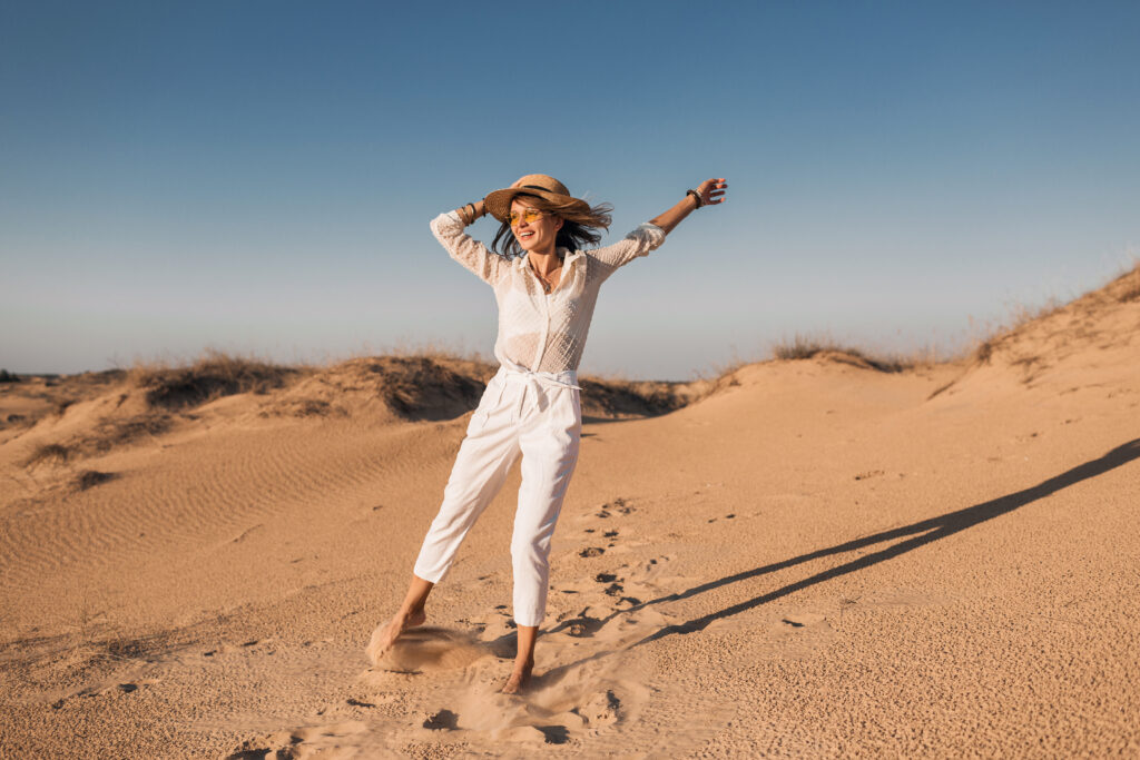 Woman dances happily in desert near las vegas because she is feeling better after going to a psychiatrist at mindwell