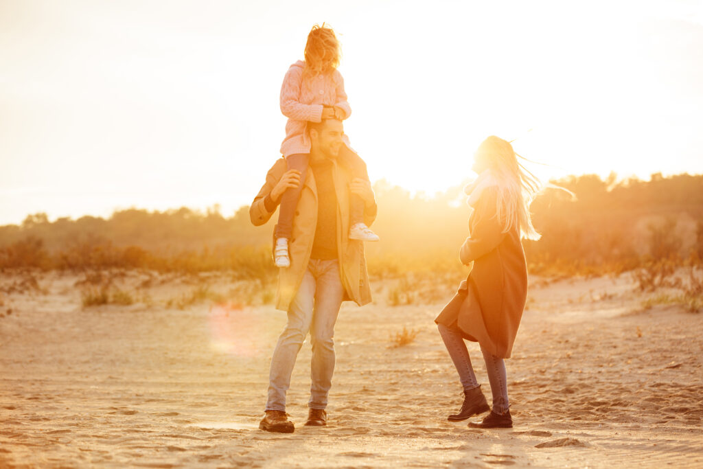 Happy father, mother, and daughter enjoying a sunset in the desert near las vegas after receiving psychiatric care at mindwell