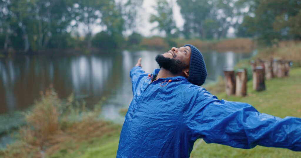 Man in woods stretching his arms to the sky near Las Vegas because he found same day psychiatric services at MindWell