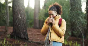 Woman in nature near Las Vegas smelling something in her hands and searching for same day psychiatrist at MindWell
