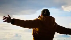 Man with Bipolar Disorder stretching arms to sky near las vegas after receiving psychiatric treatment at mindwell