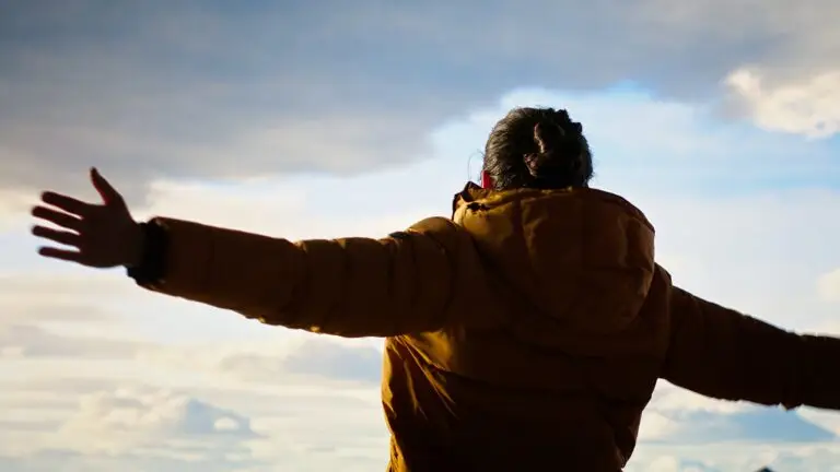 Man with Bipolar Disorder stretching arms to sky near las vegas after receiving psychiatric treatment at mindwell