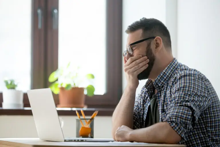 person sitting at desk looking tired in las vegas potentially with cerebral folate deficiency