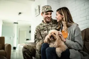 wife and husband and dog sitting on couch in las vegas considering if spouses can get vicarious ptsd