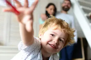 child reaching for something with parents in the background wondering if their child needs adhd medication in las vegas