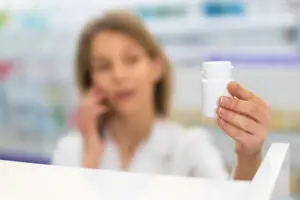 pharmacist in las vegas looking at bottle considering shortage of leucovorin