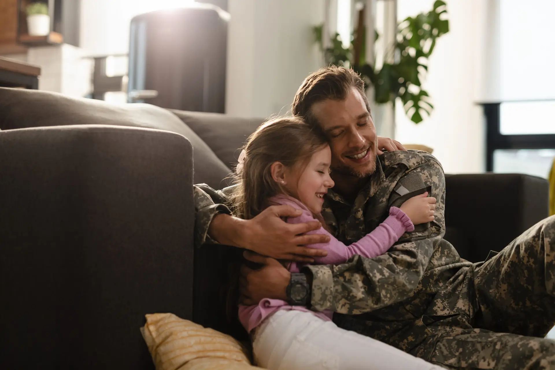 veteran hugging child on couch of home in las vegas worrying about spouses mental health