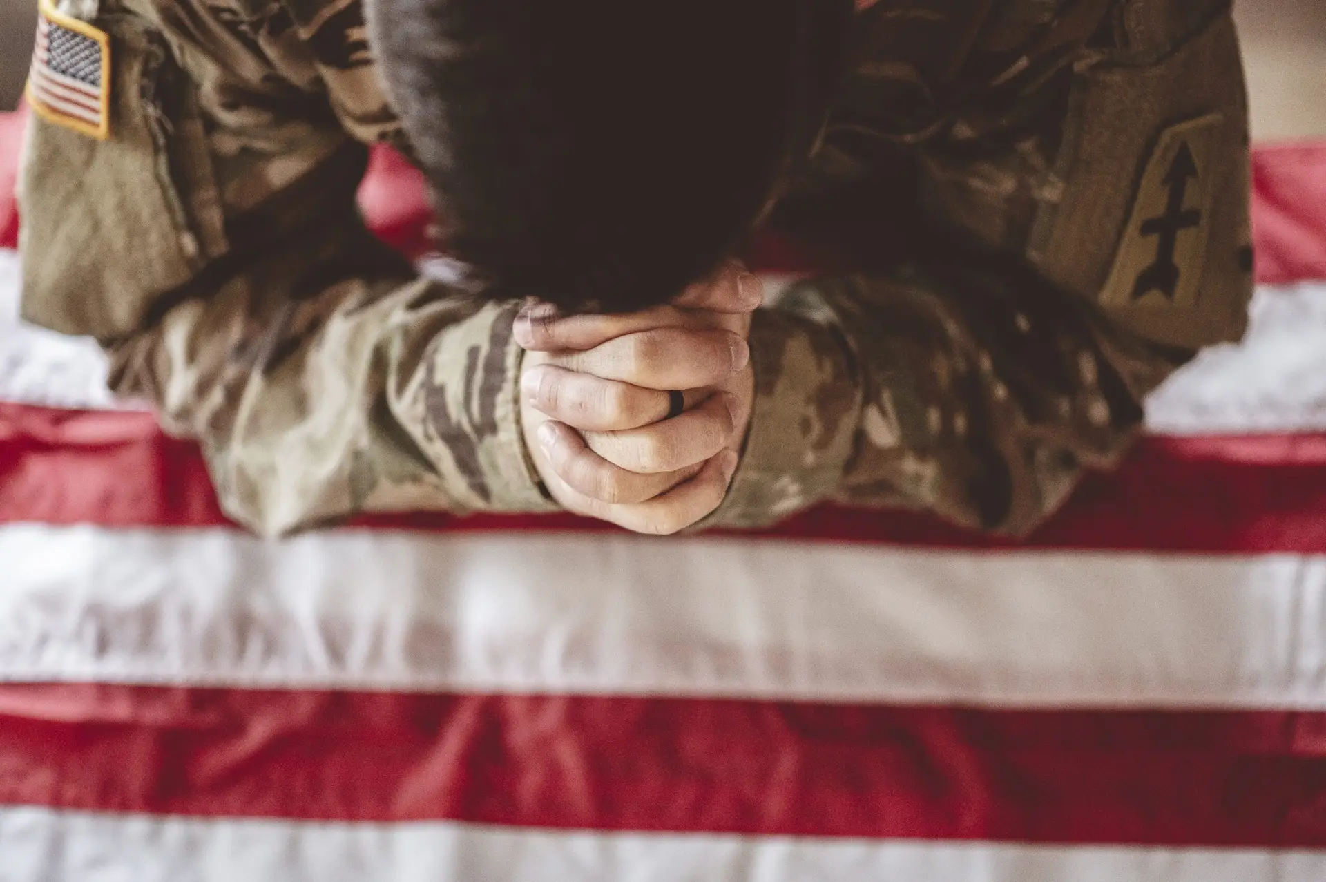 veteran clasping hands over american flag dealing with veteran sleep disorder in las vegas