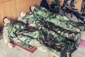 three military men laying down trying to sleep after deployment in las vegas
