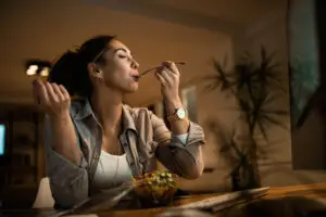 woman having late night snack in las vegas wondering if overeating or binge eating disorder