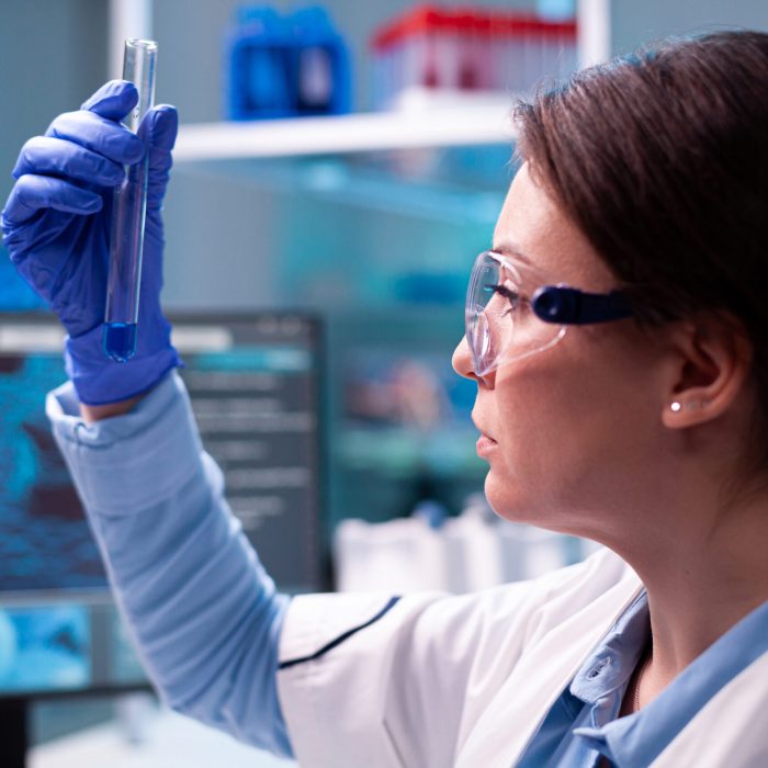 Woman looking at test tube for genetic testing for psychiatric services in las vegas at mindwell