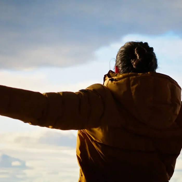 Man with Bipolar Disorder stretching arms to sky near las vegas after receiving psychiatric treatment at mindwell