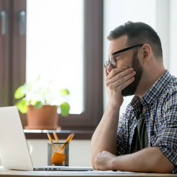 person sitting at desk looking tired in las vegas potentially with cerebral folate deficiency