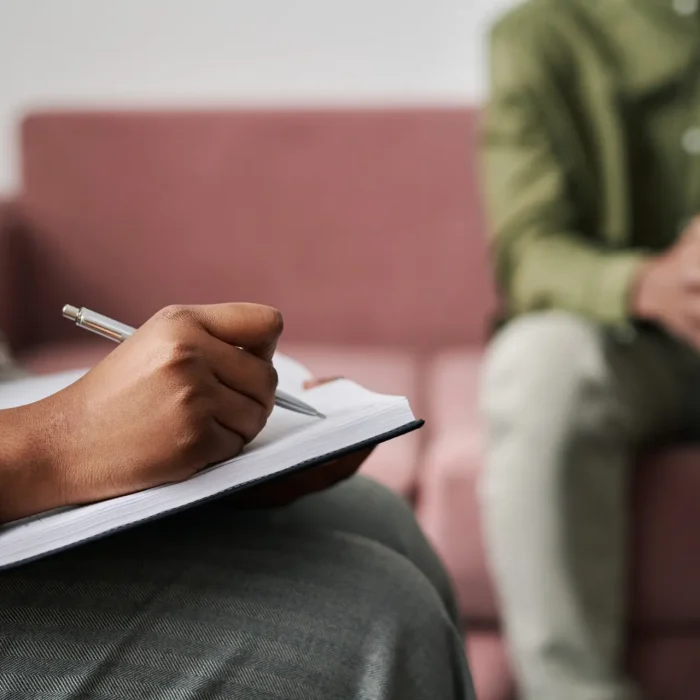 psychiatrist or pmhnp writing on clipboard with patient in las vegas