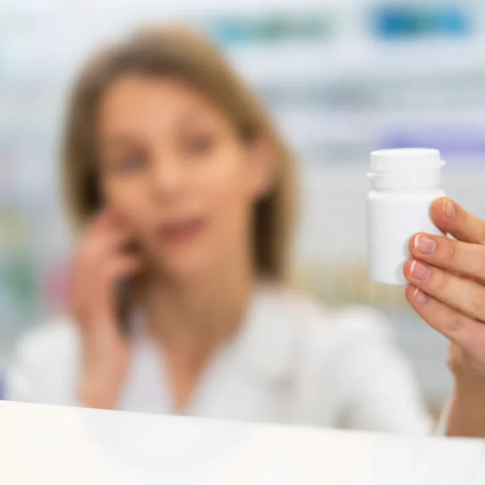 pharmacist in las vegas looking at bottle considering shortage of leucovorin