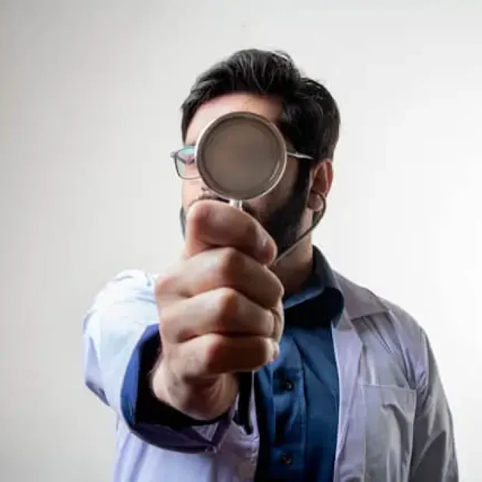 A doctor holding a magnifying glass