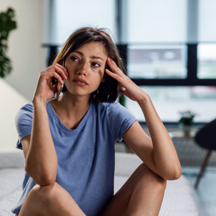 woman sitting on floor of living room dealing with what might potentially be insanity in las vegas